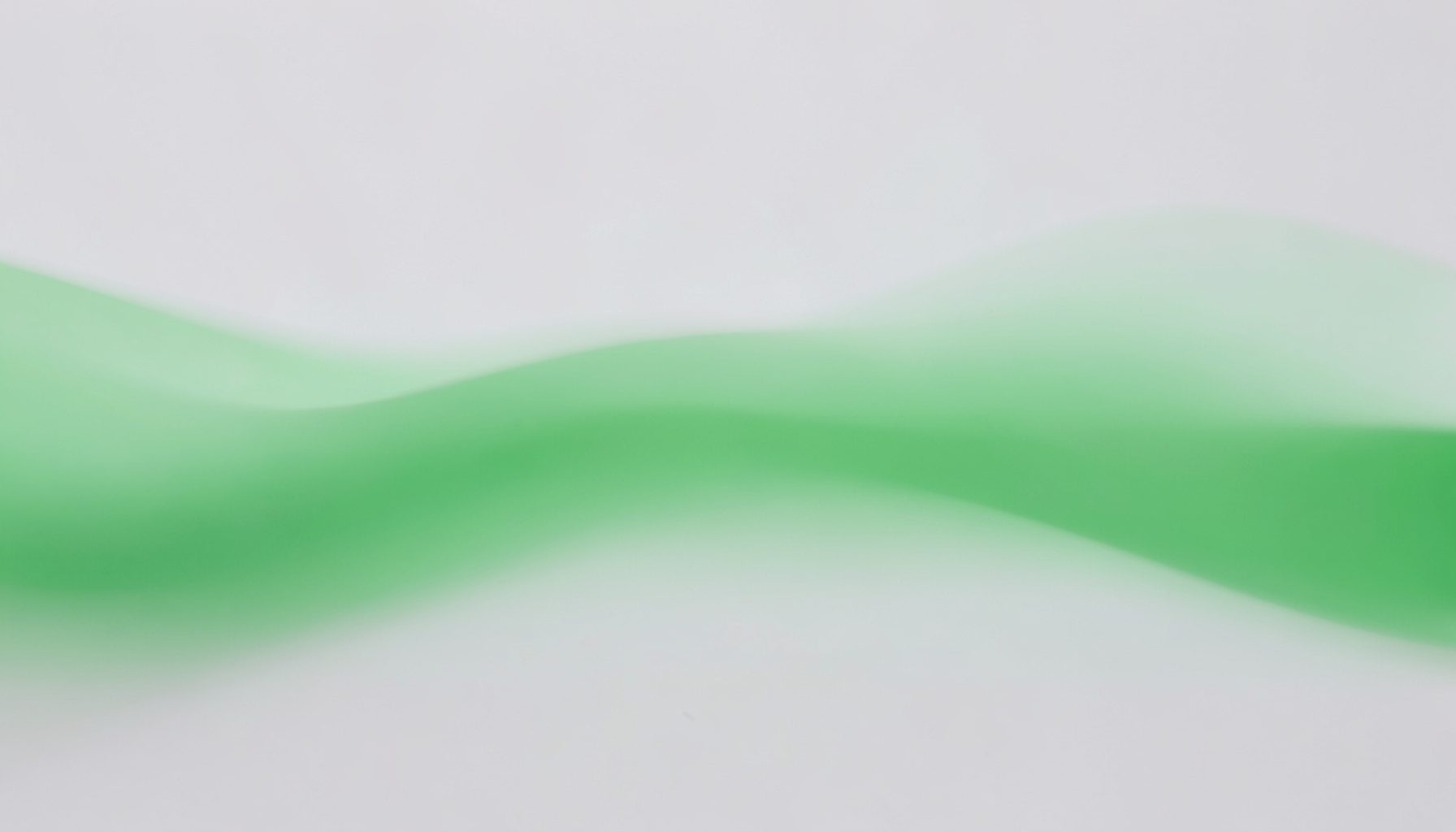 Soft abstract green wave on a light gray background, calm and minimal